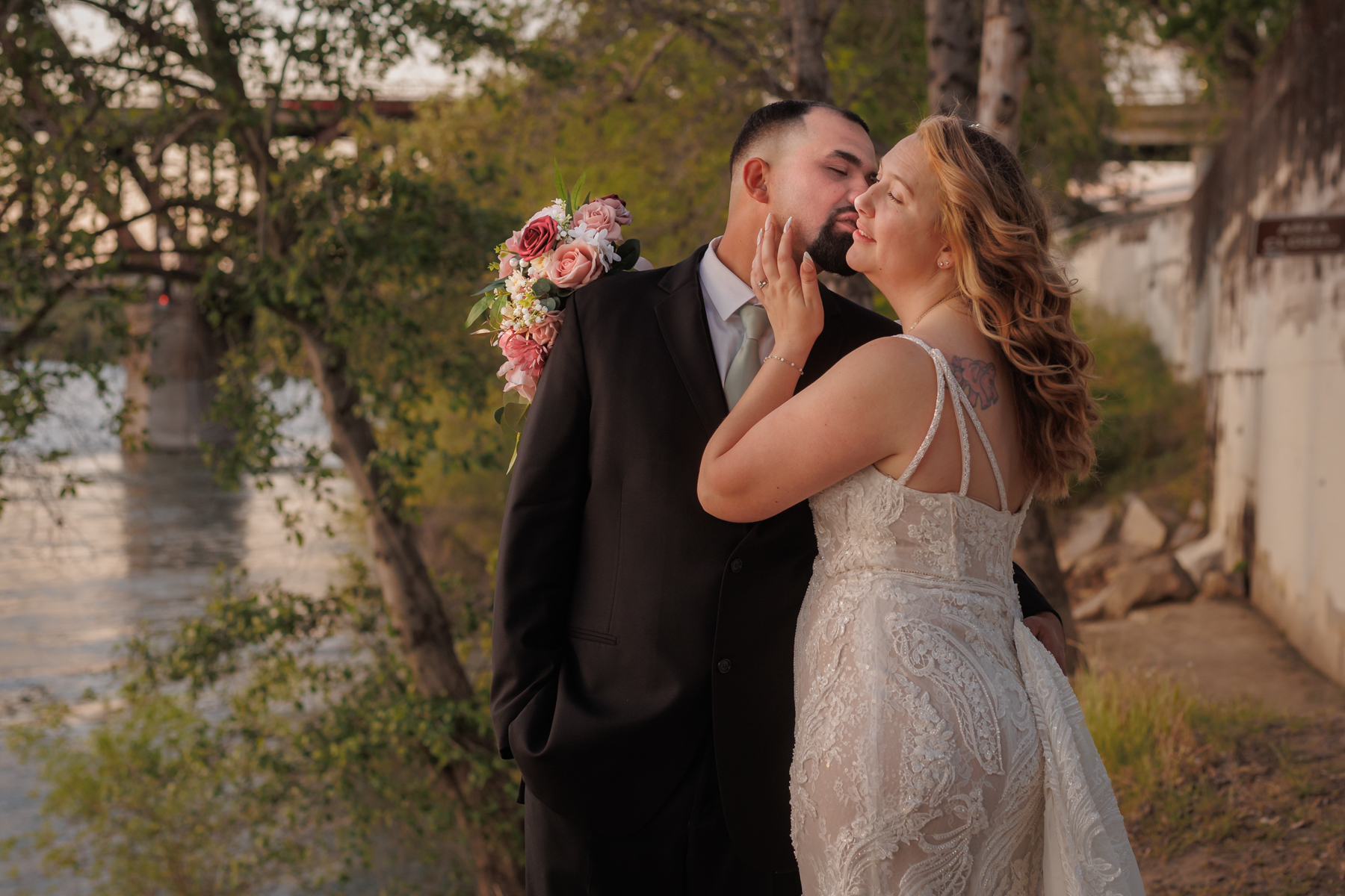 bride and groom enjoying a golden hour kiss at the Old Sacramento Riverfront during their California wedding