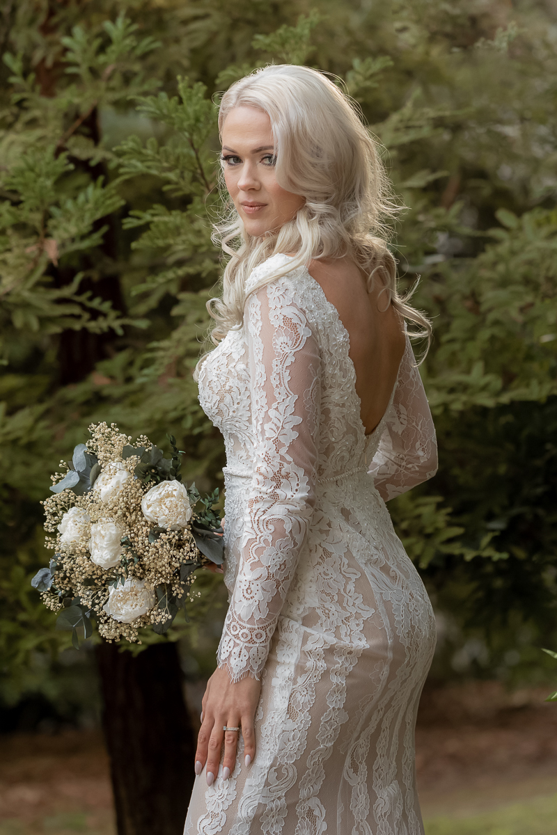 Bride standing among trees in Napa Valley