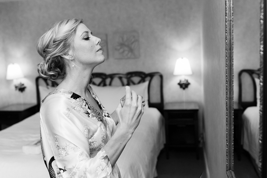 Bride putting on perfume during getting ready at Bel Air Country Club wedding