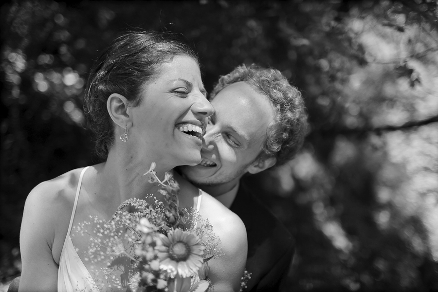 Bride and groom playfully flirting during wedding portraits at Muir Woods