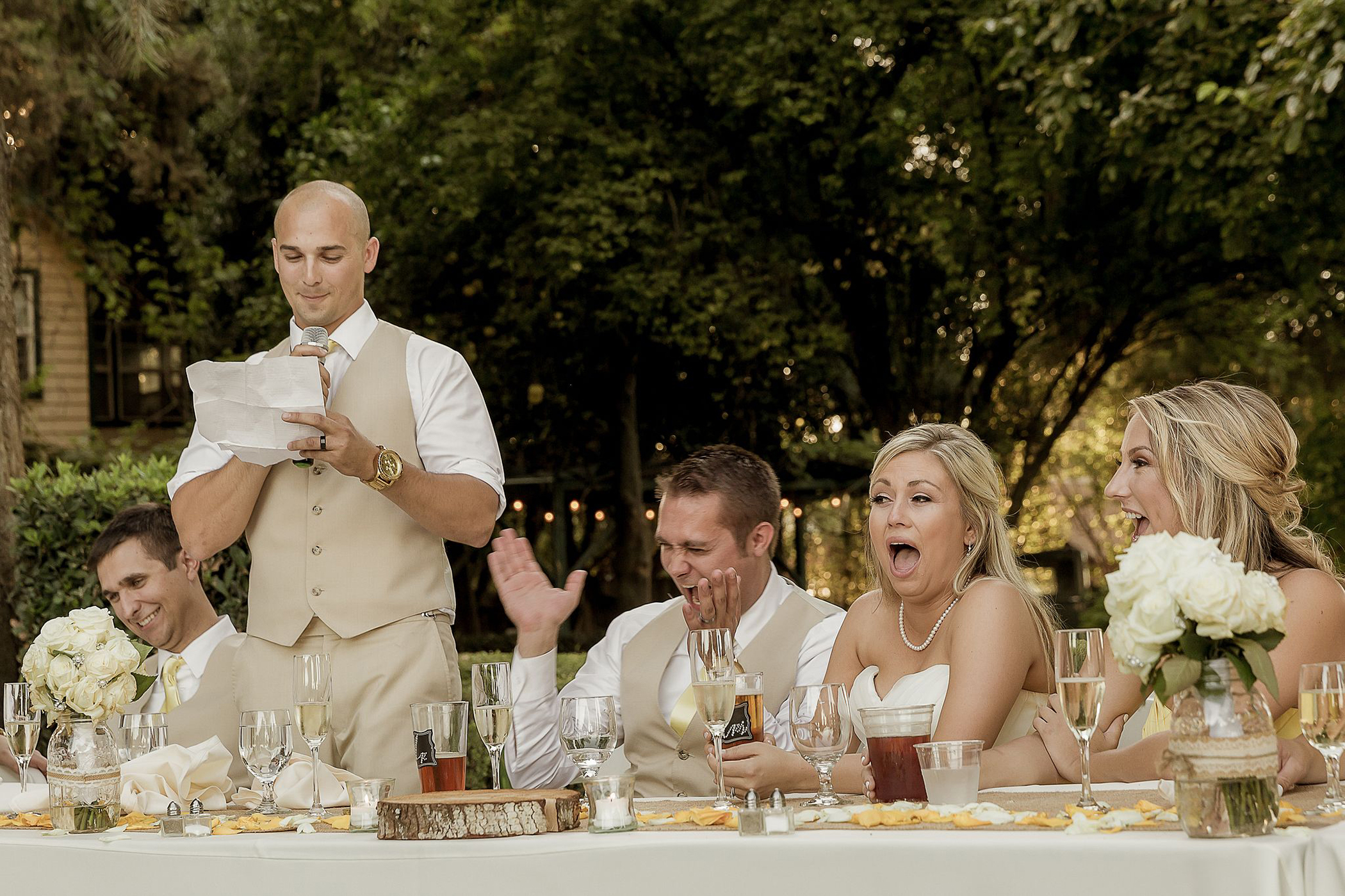 Bridal party laughing during a funny and candid wedding speech at Yolanda Ranch in Woodland, Ca