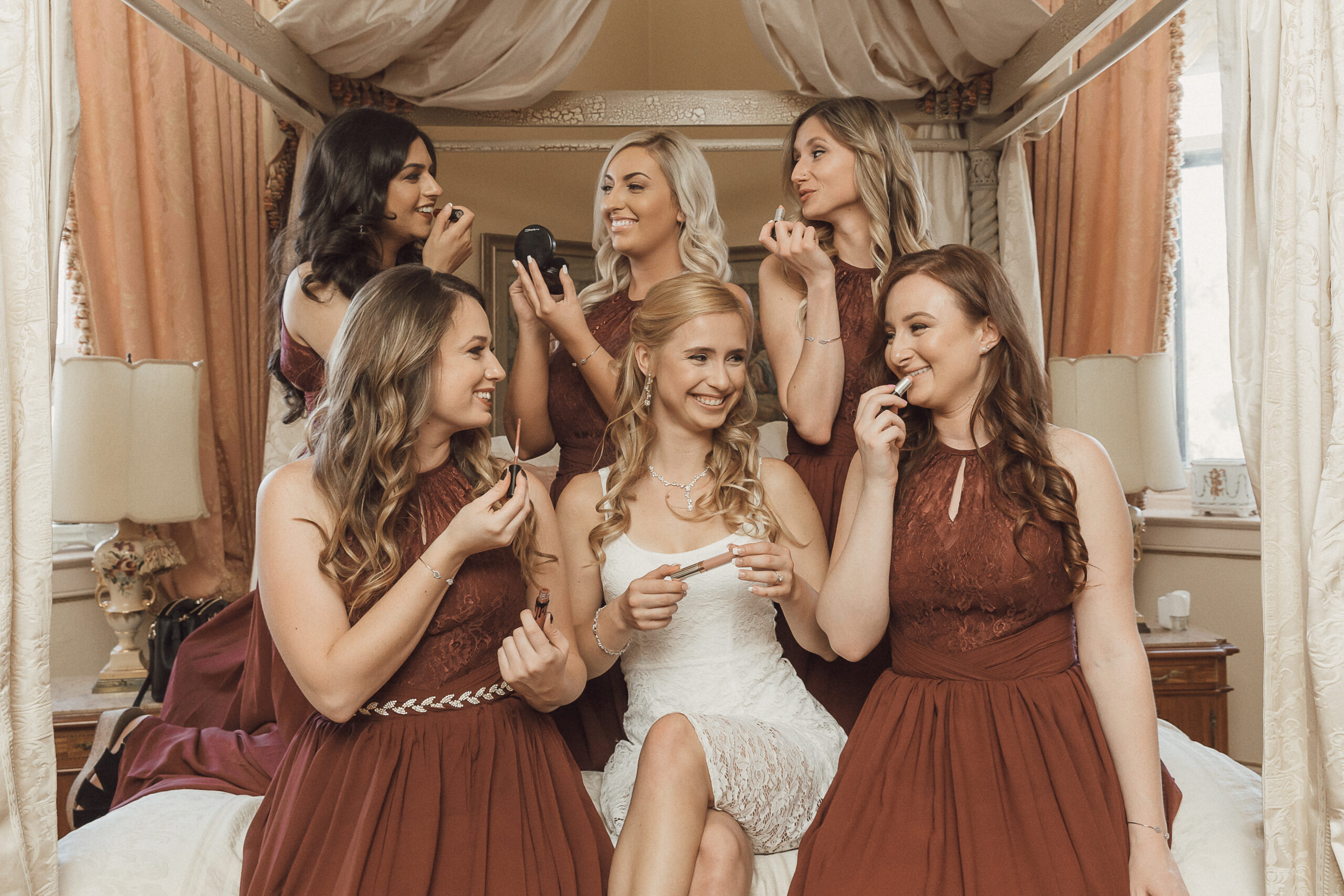 Bride and bridesmaids having fun while getting ready at Jefferson Street Mansion