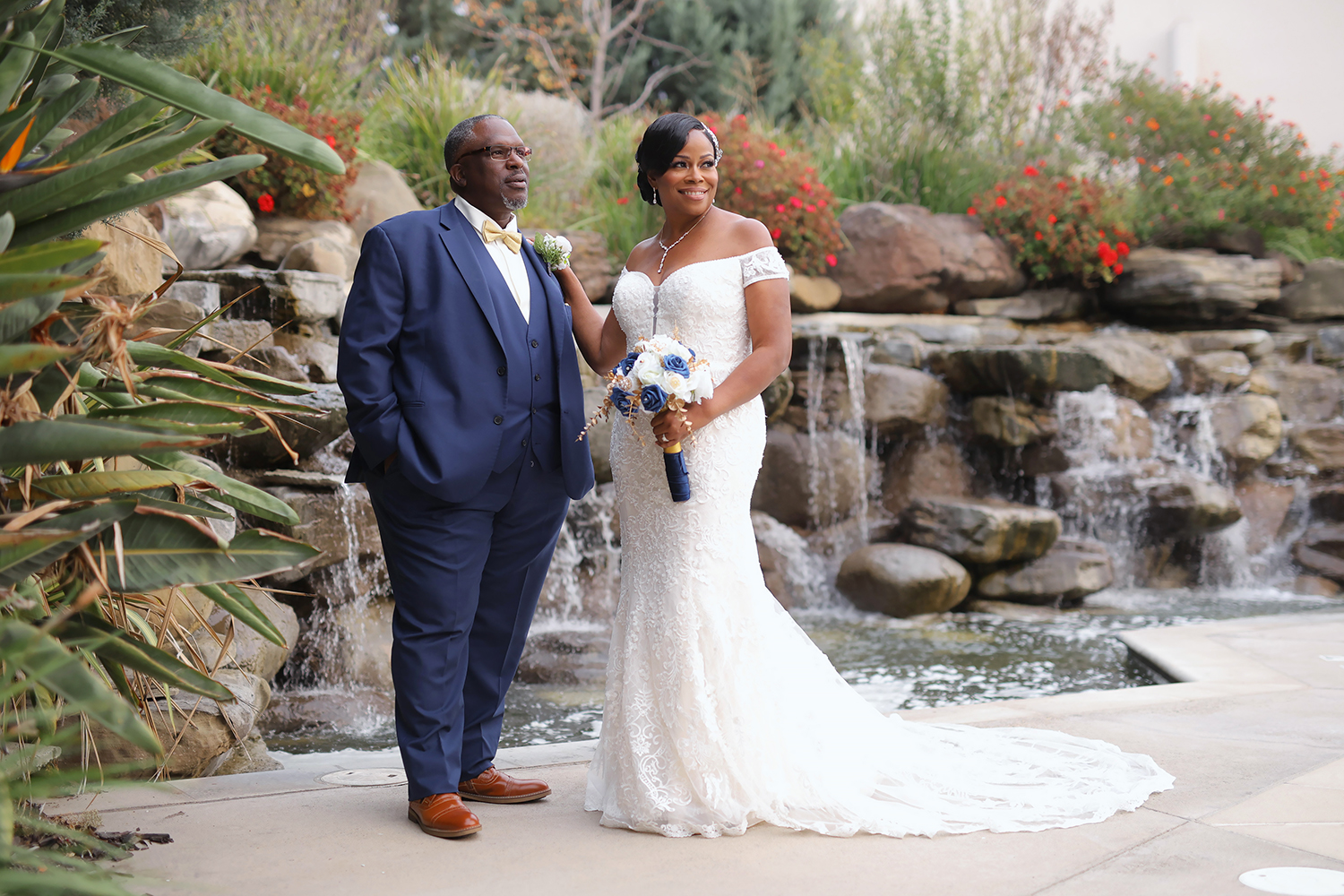 Beautiful wedding couple portrait outdoors by waterfall