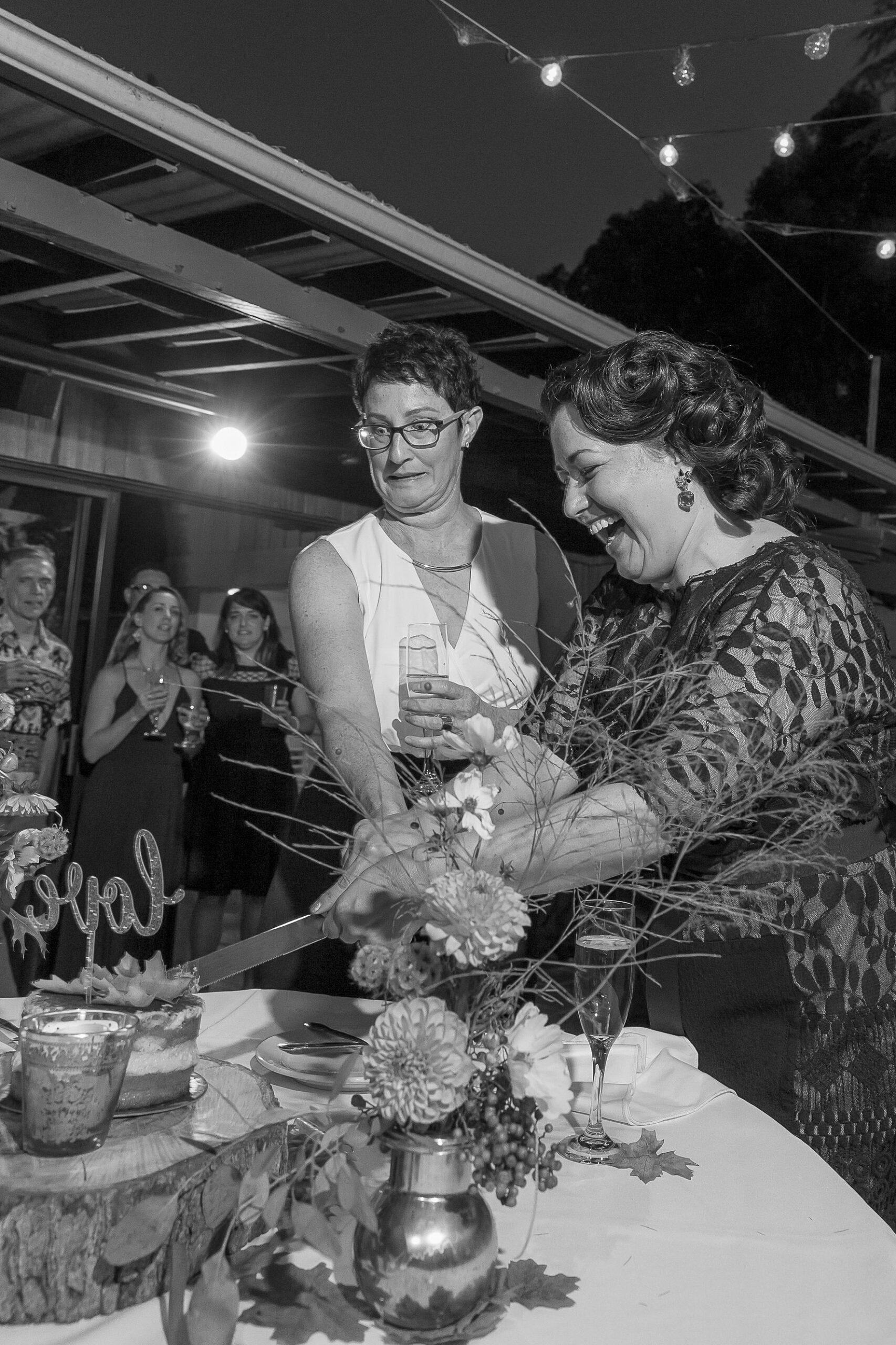 LGBTQ+ couple cutting wedding cake at Hiddenbrooke Hills in Vallejo Ca