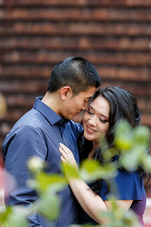 engaged couple enjoying a quiet romantic moment by a fountain in the gardens of uc davis arboretum