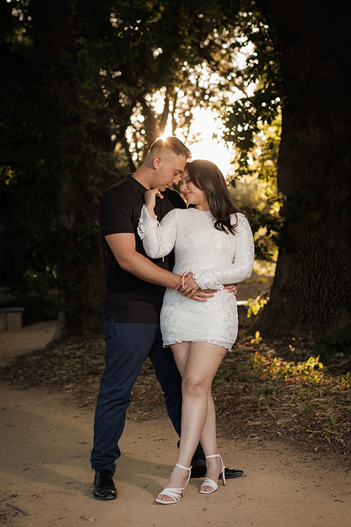 couple embracing at golden hour along the uc davis arboretum during a davis ca engagement session professional photography