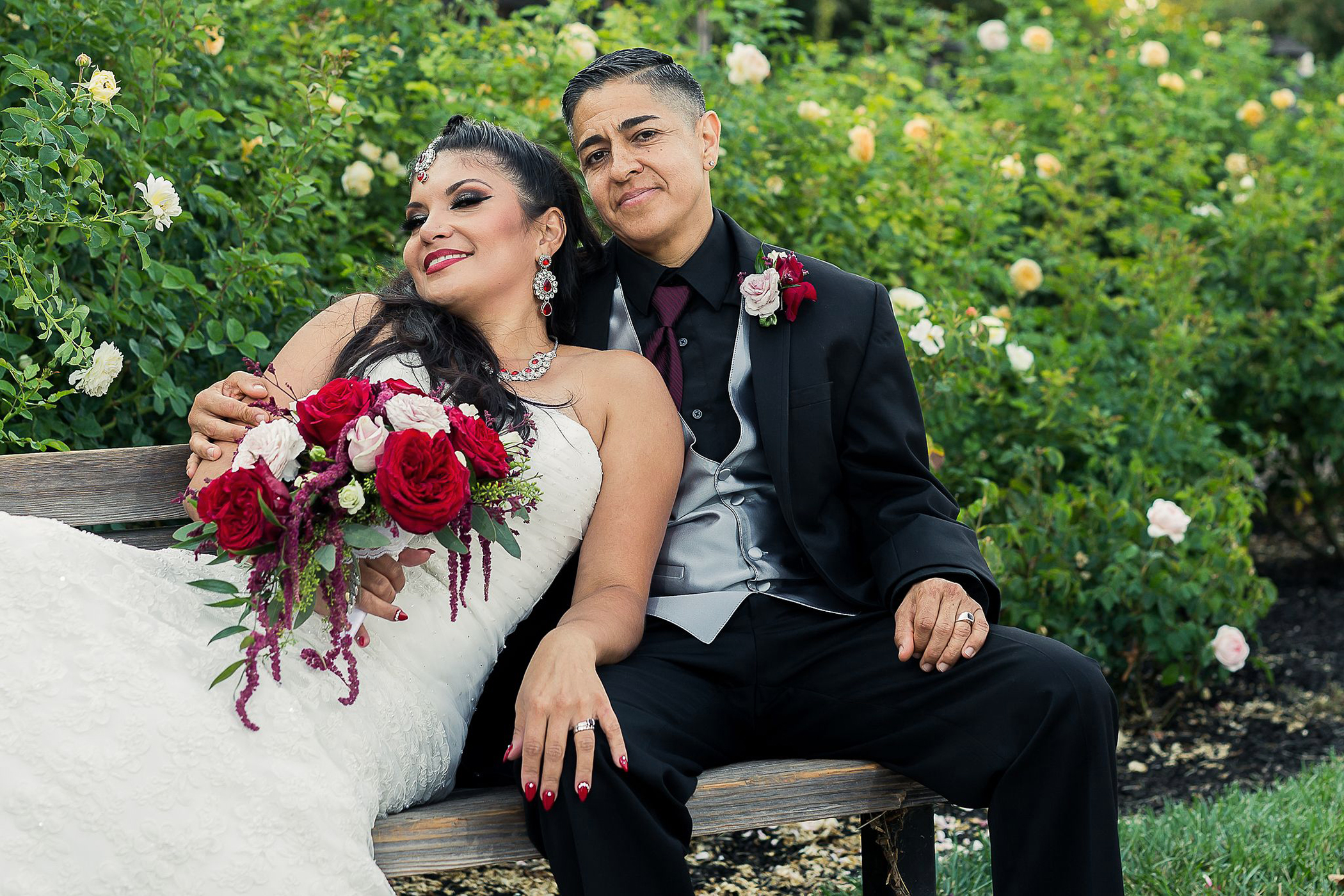 LGBTQ couple sharing a romantic, cuddling moment on a bench at Heather Farm in Walnut Creek, California