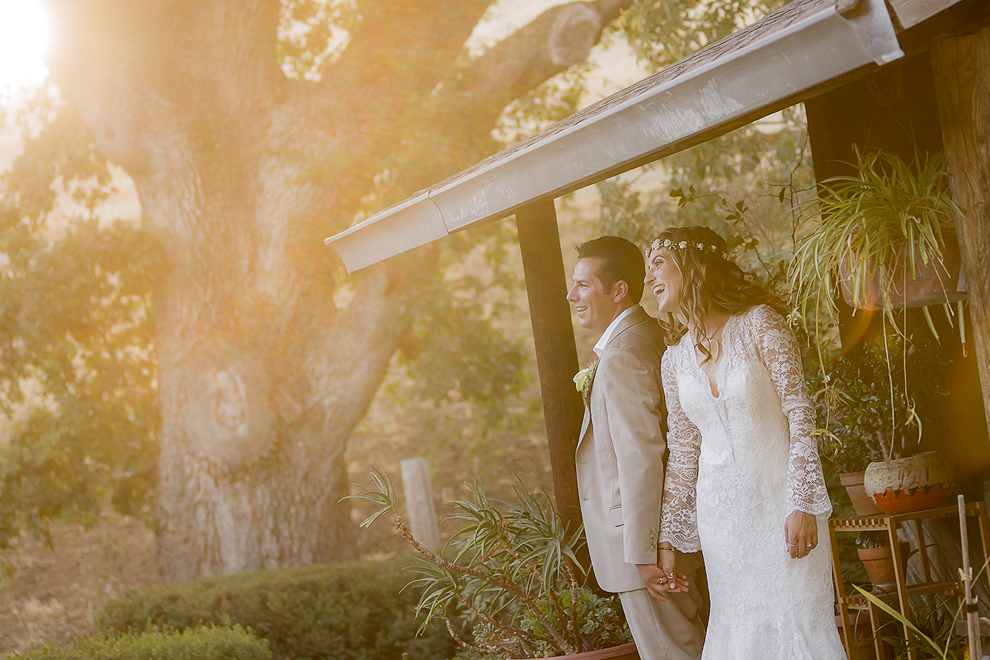 bride and groom sharing a romantic and fun sunset moment in the woodland area of Park Winters in Winters, California