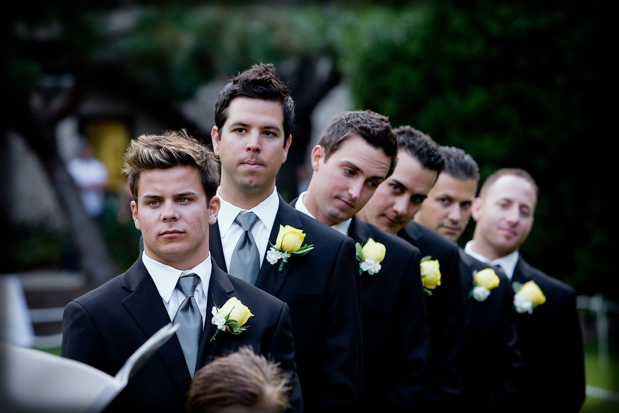 dramatic moment of groomsmen standing at the altar during a sacramento wedding ceremony