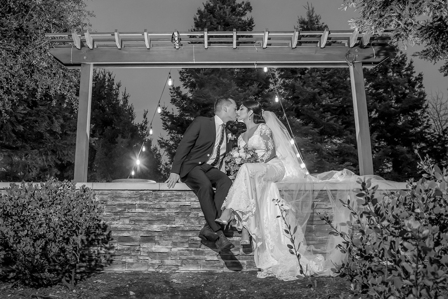 bride and groom sharing a romantic nighttime kiss at Chardonnay Golf Club in Napa, California