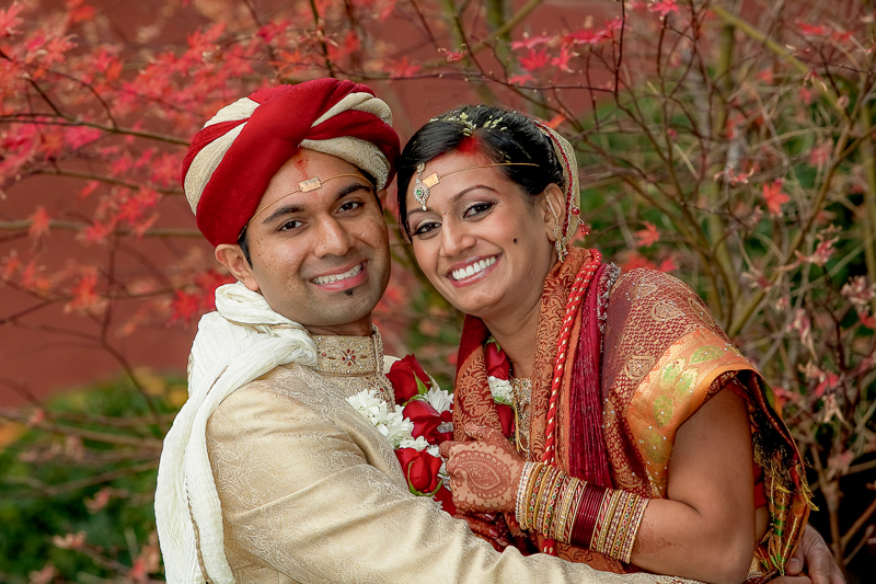 Indian bride and groom posing among fall colors at The Club at Castlewood in Pleasanton California