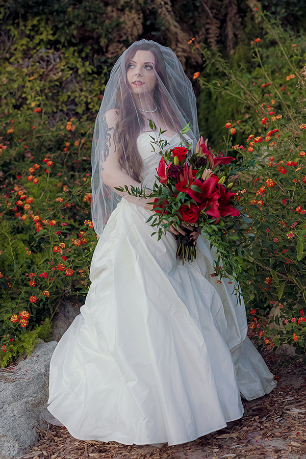 Romantic veiled bride standing in soft light during wedding portraits at Brownstone Gardens, a beautiful venue in Oakley CA