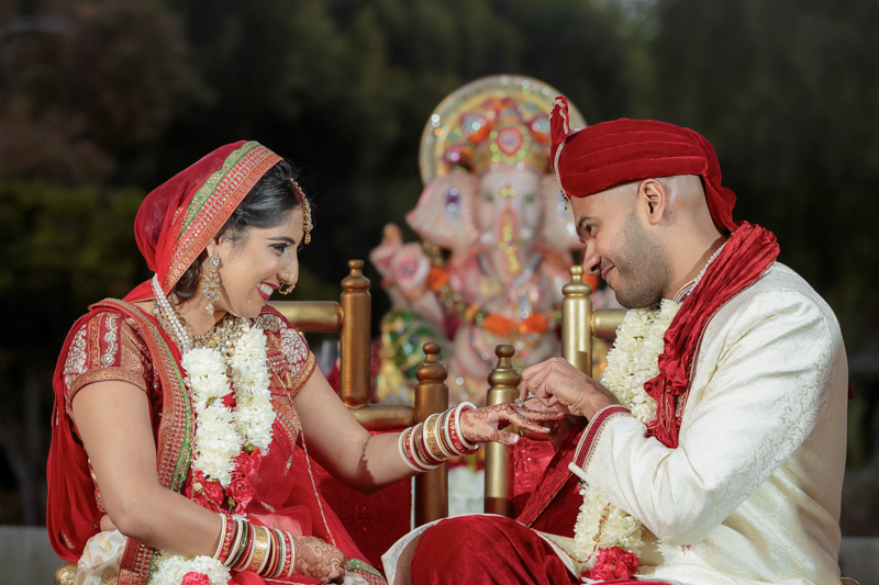 Indian bride and groom exchanging rings during wedding ceremony at Sunset Banquet Hall in Vacaville California