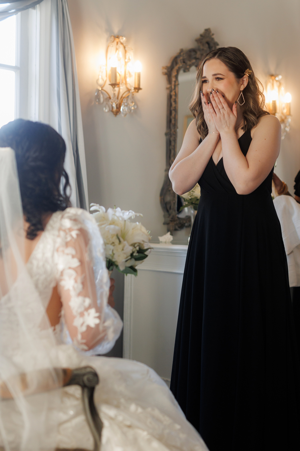 bridesmaid reacting emotionally to the bride during a wedding at Grand Island Mansion in Walnut Grove, California