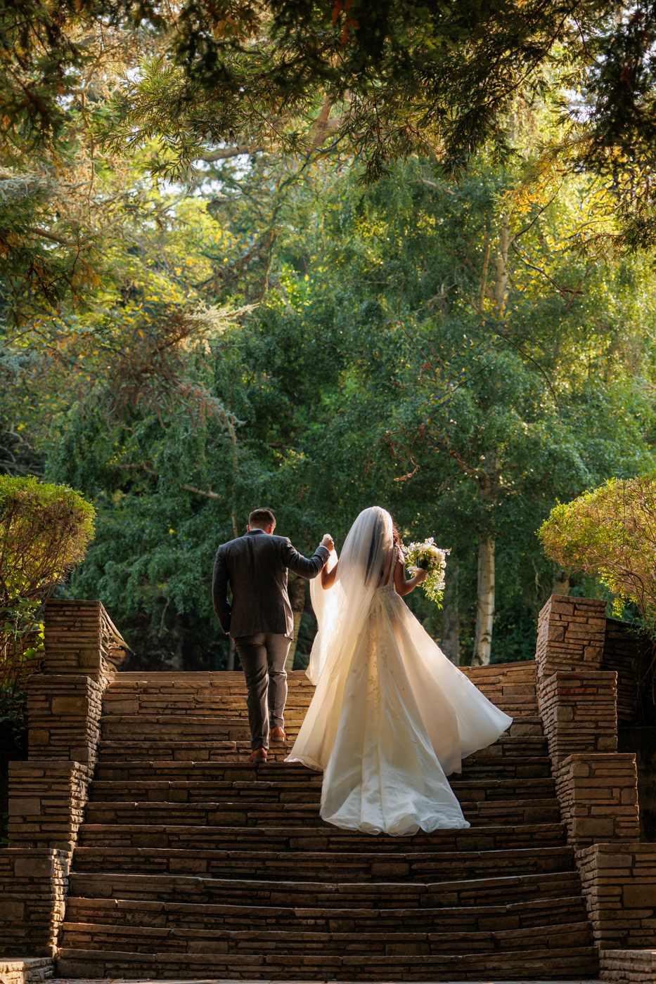 bride and groom walking up the stairs together after their wedding ceremony at Hacienda de la Flores in Lafayette, California