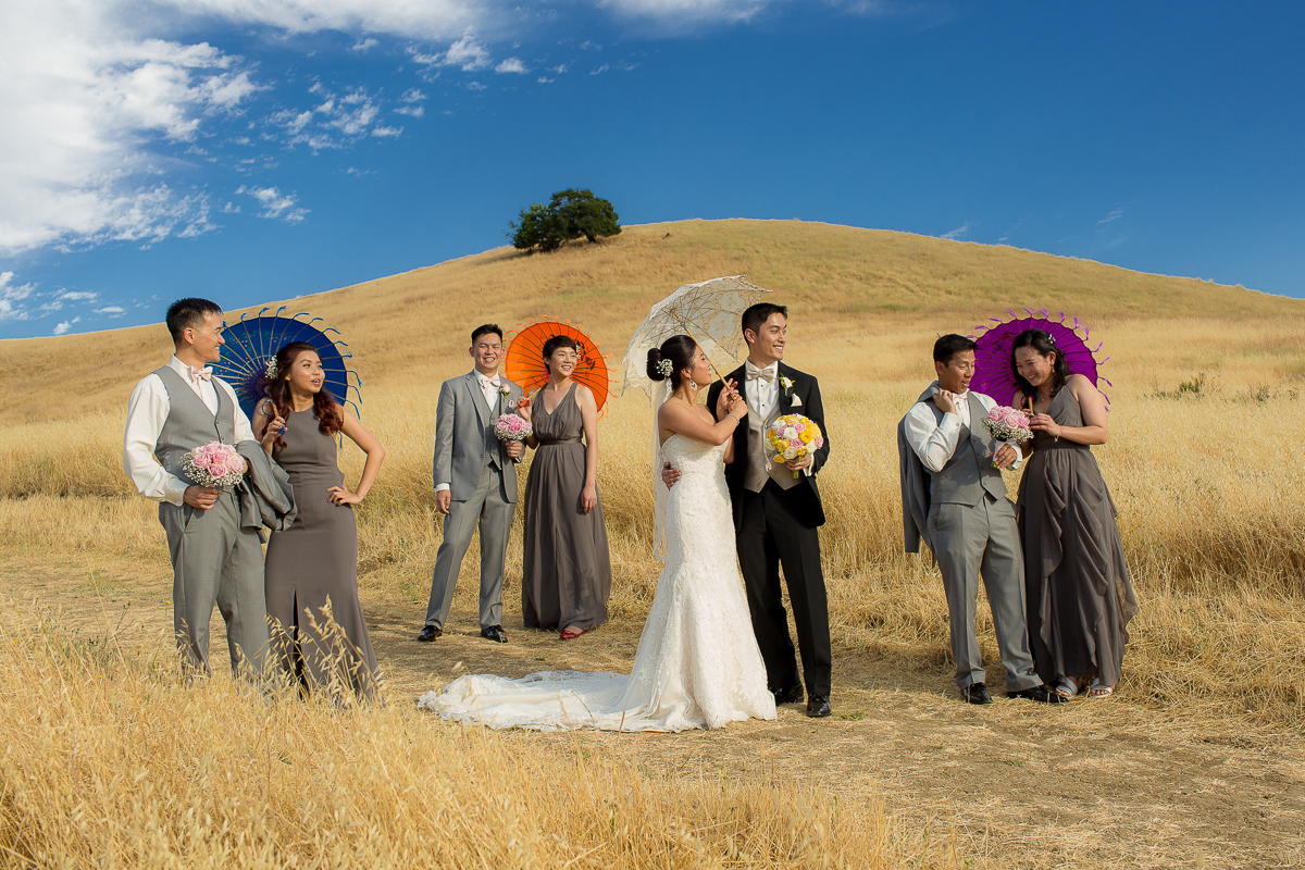 wedding party celebrating with colorful umbrellas at Meritage Resort and Spa in Napa Valley, California