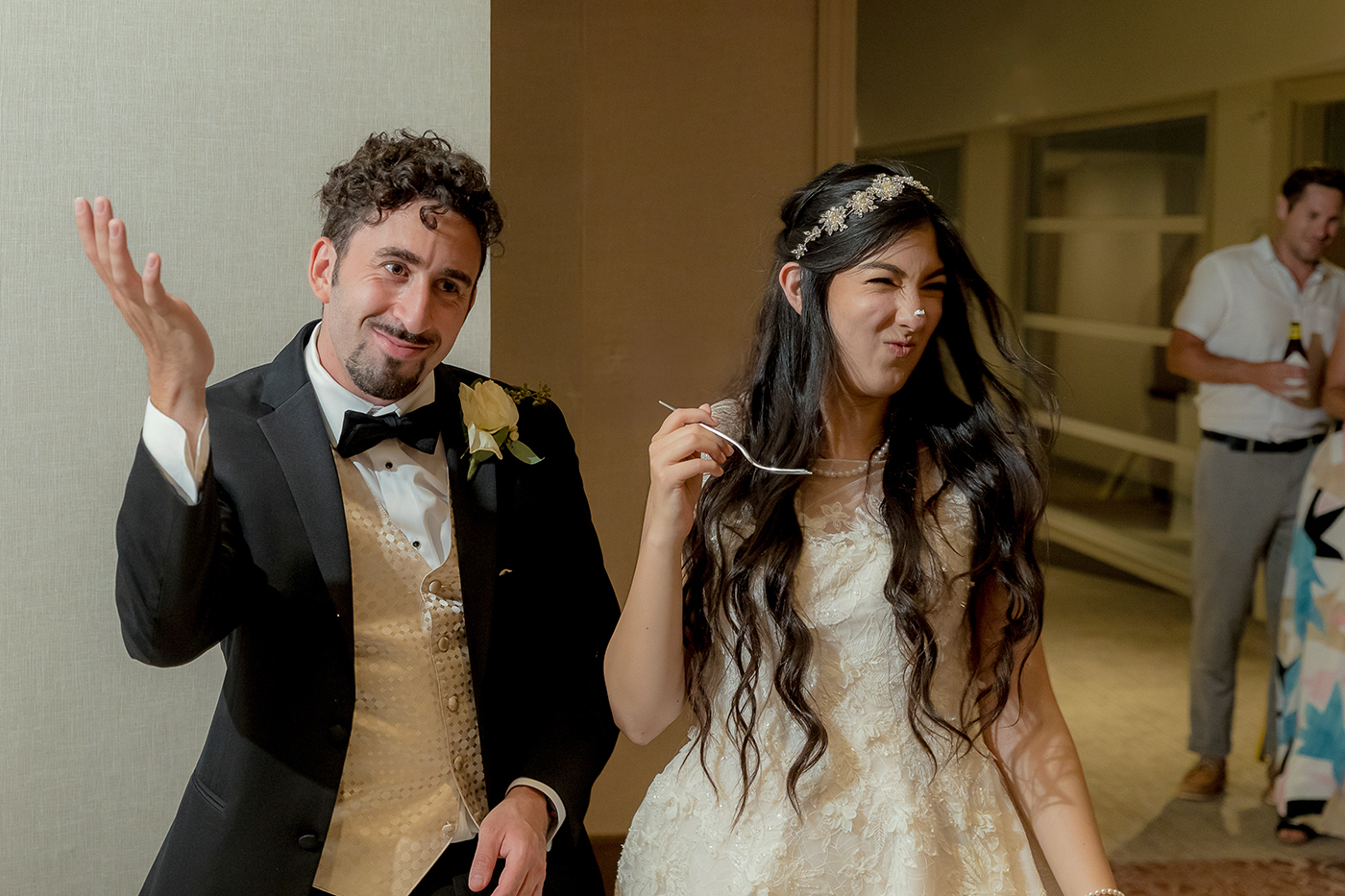 playful wedding cake cutting moment with frosting on the bride’s nose at Chaminade Resort & Spa in Santa Cruz, California