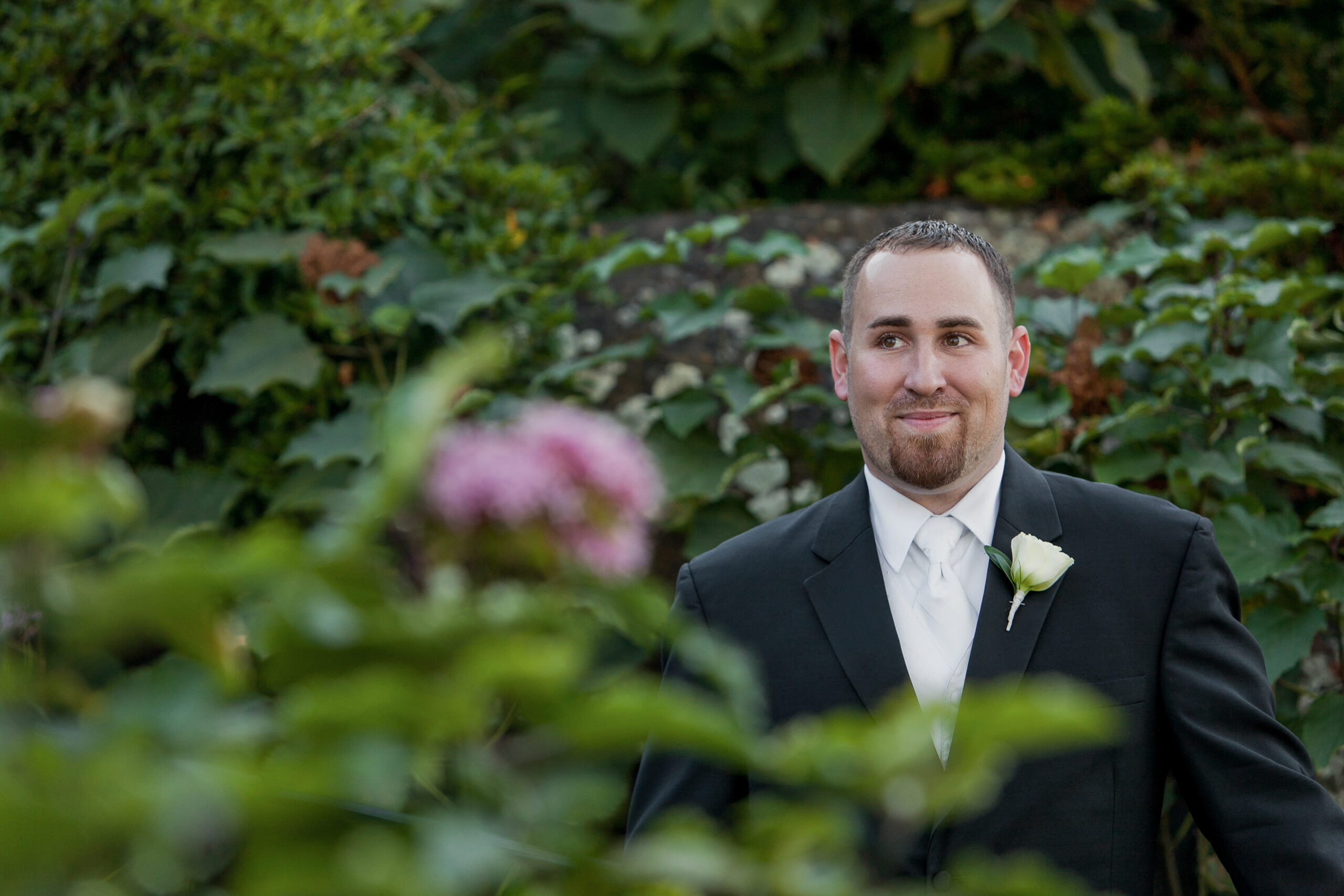stylish groom in garden at Vizcaya Sacramento, California, ready for his wedding, captured beautifully