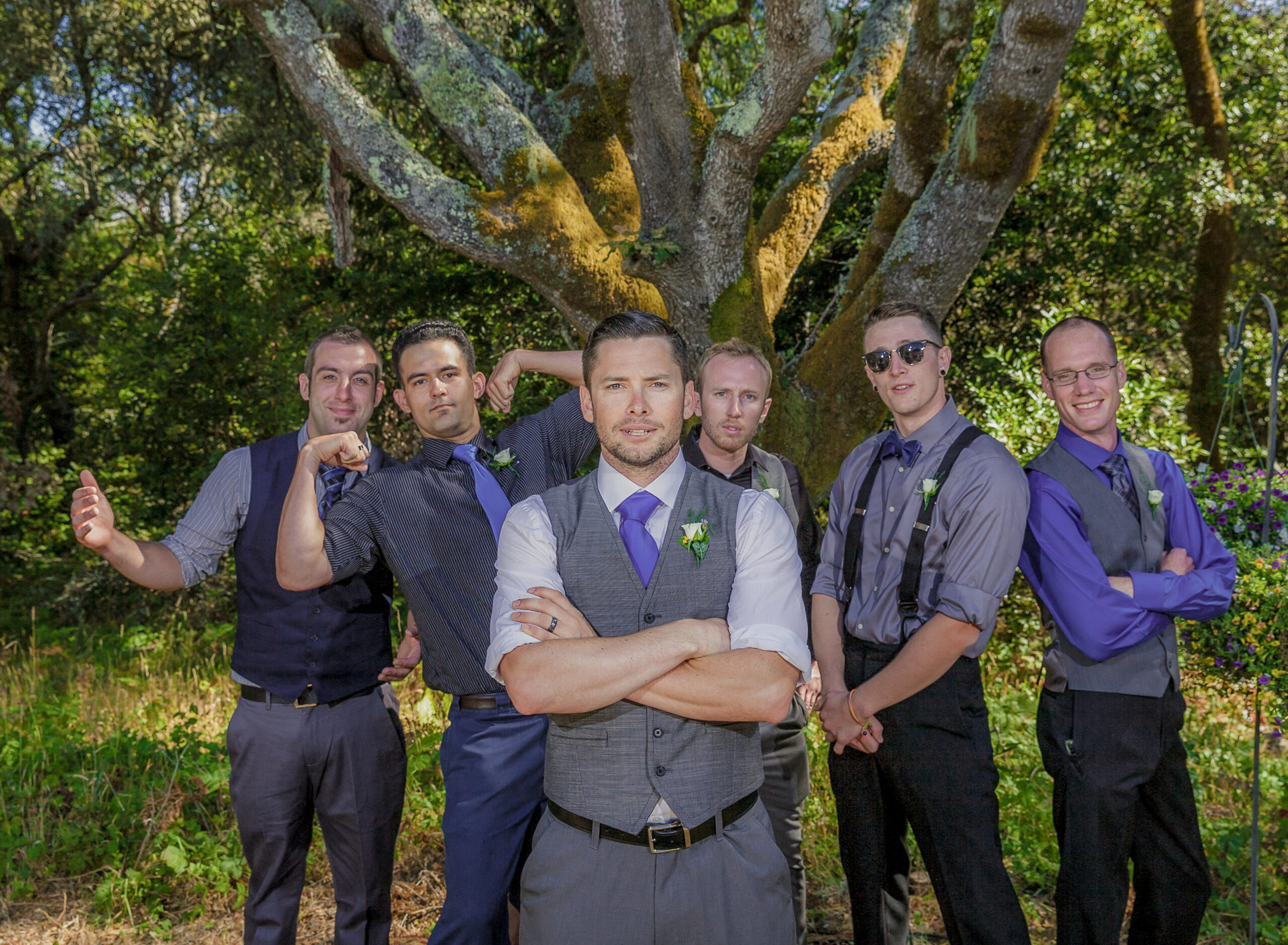 dramatic yet fun wedding photo of groom and groomsmen in forest at Ralston White Retreat in California