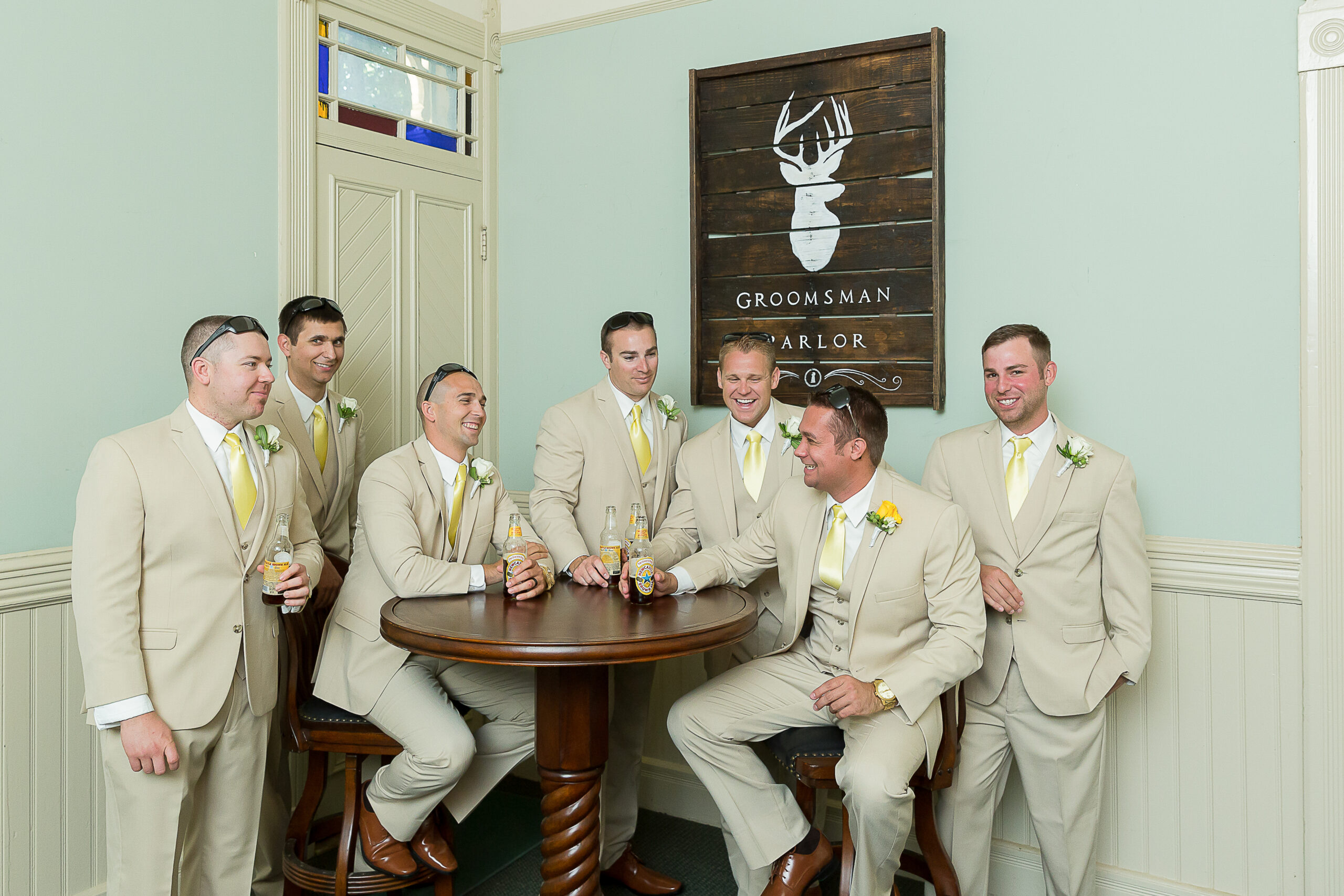 fun groom with his groomsmen inside the parlor at Yolanda Ranch during a California wedding