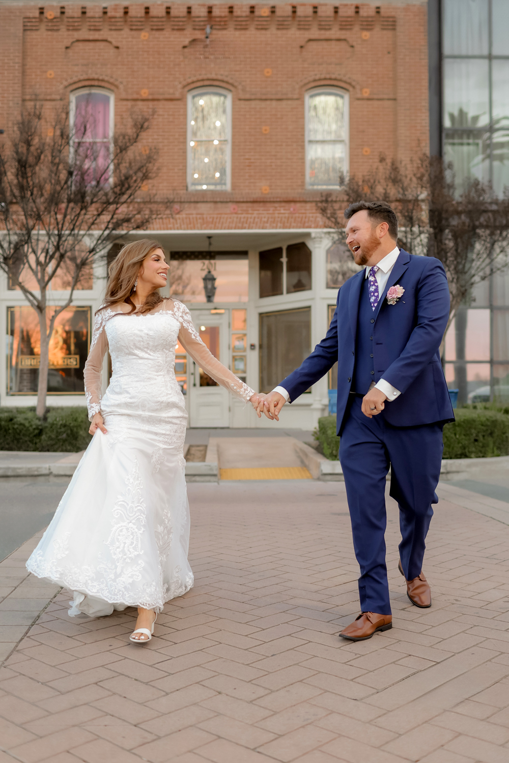 bride and groom sharing a fun moment in downtown Napa, California during their wedding session