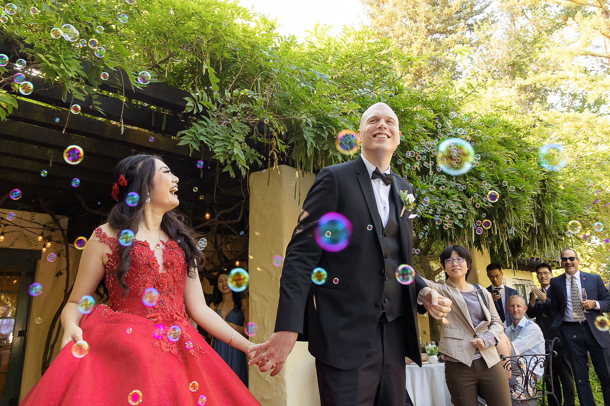 Bride and groom entering reception with bubbles at Allied Arts Guild in Menlo Park