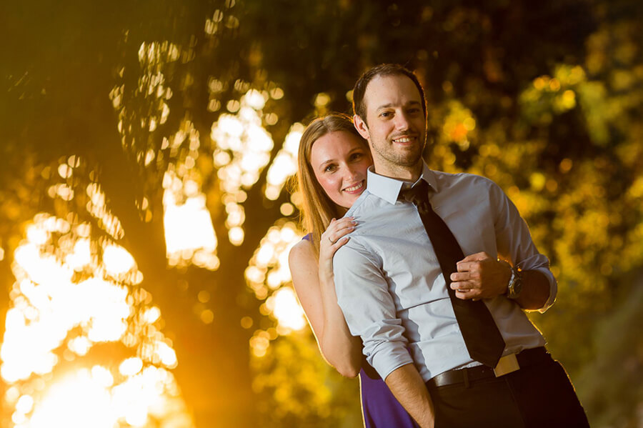 Engagement couple in UC Davis Arboretum at sunset with natural golden light and calm romantic atmosphere