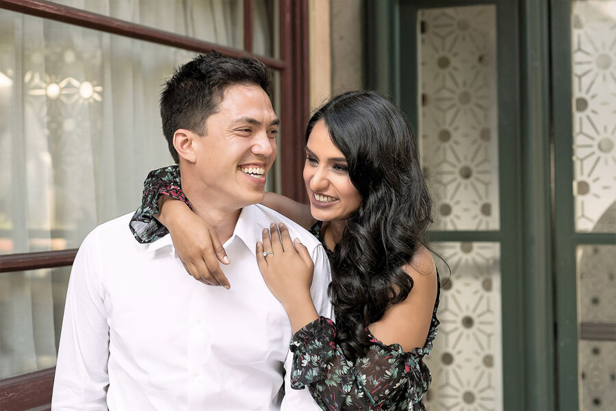Engagement couple in downtown San Francisco with urban backdrop, natural light and easy candid connection