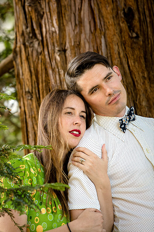 Couple in Muir Woods National Monument among towering redwood trees, soft filtered light and quiet romantic moment
