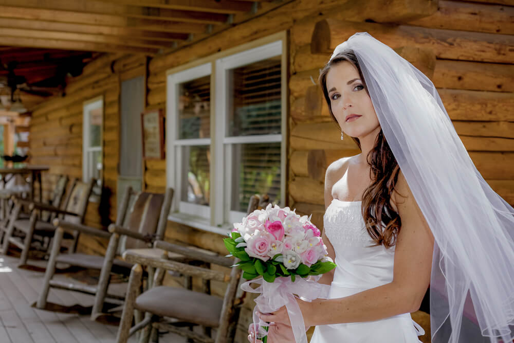 Bride standing outside Log Cabin venue at the Presidio in San Francisco California before wedding ceremony