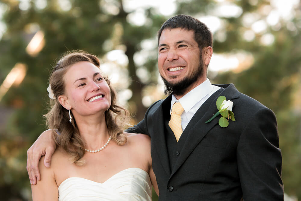 Bride and groom sharing a joyful toast during wedding celebration at Meeks Bay on Lake Tahoe California