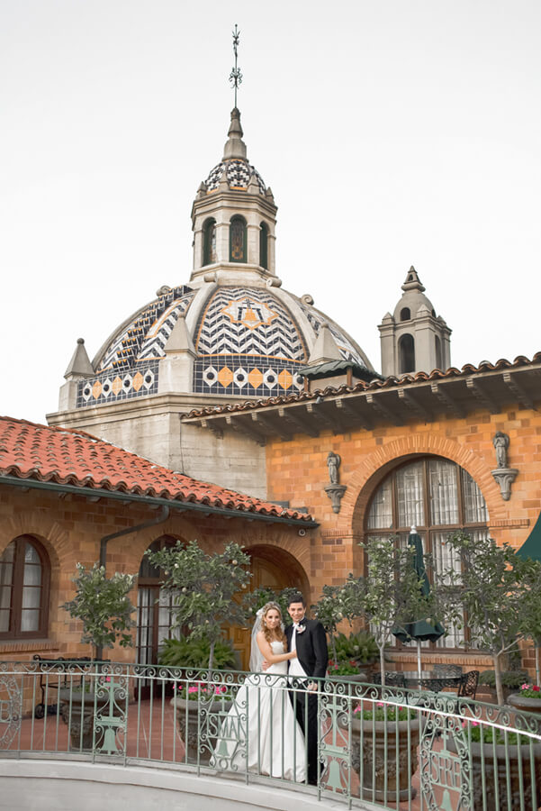 Romantic wedding portrait on a balcony at the Mission Inn Hotel & Spa in Riverside, California