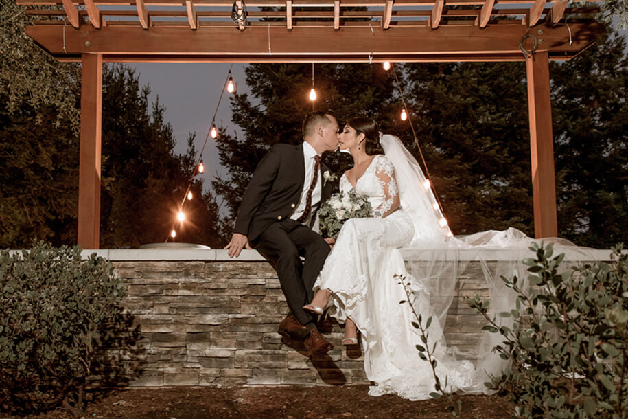 Romantic nighttime wedding kiss at Chardonnay Golf Club wedding venue in Napa Valley