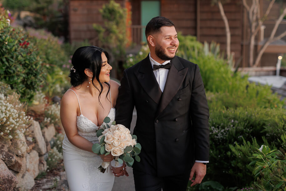 Joyful couple laughing together at sunset overlooking the coast at Hyatt Carmel Highlands wedding venue