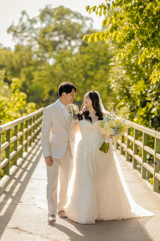 Bride and groom on bridge at Haggin Oaks in Sacramento Ca