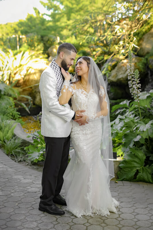 Bride and groom embracing at Bridal Falls in Brownstone Gardens in Oakley, California, during their wedding day.