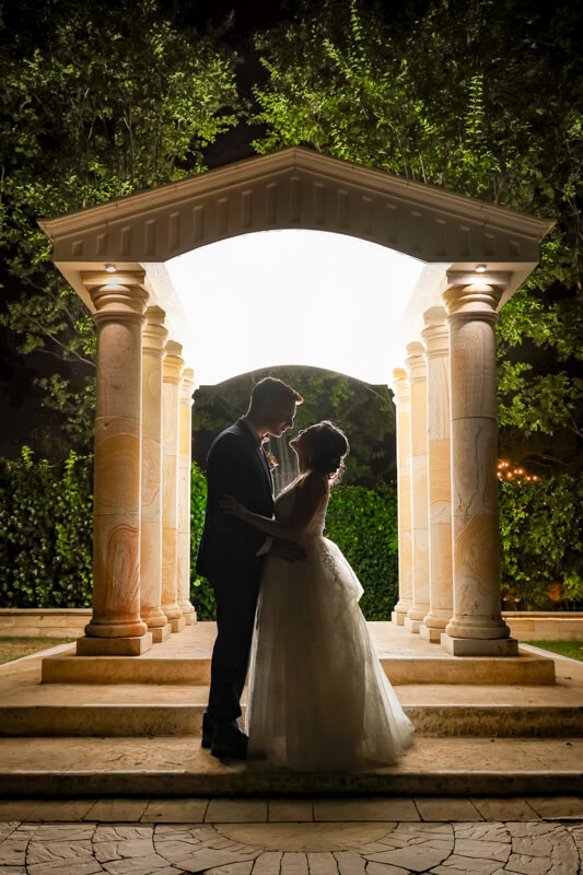 Glowing pavilion at Brownstone Gardens illuminated at night during a wedding reception