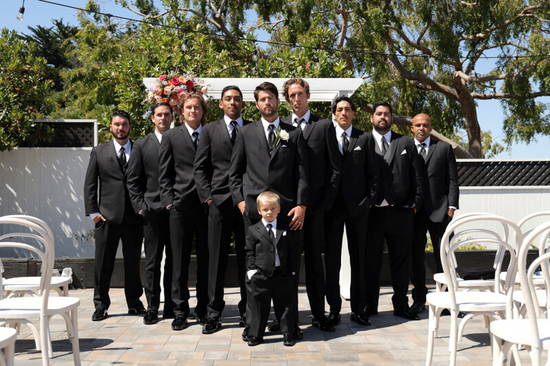 Stylish groomsmen portrait outside The Perry House in Monterey, Ca
